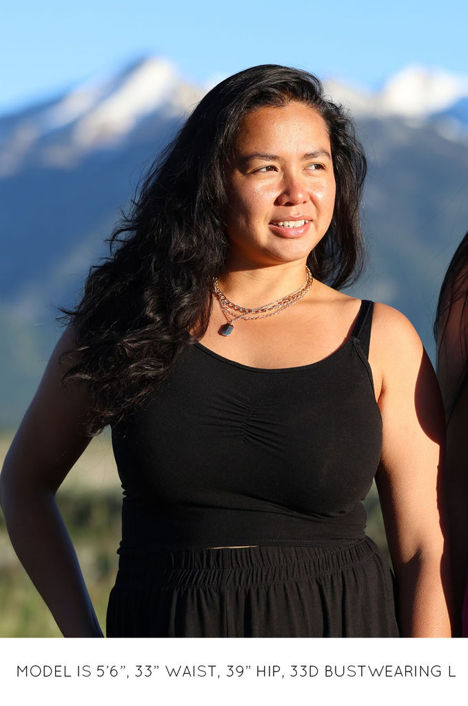 Model wearing a black Miakoda Brami crop top. 