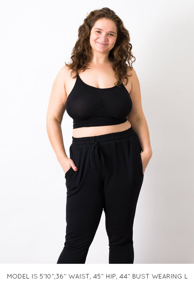 Model wearing black Miakoda Brami crop top. 