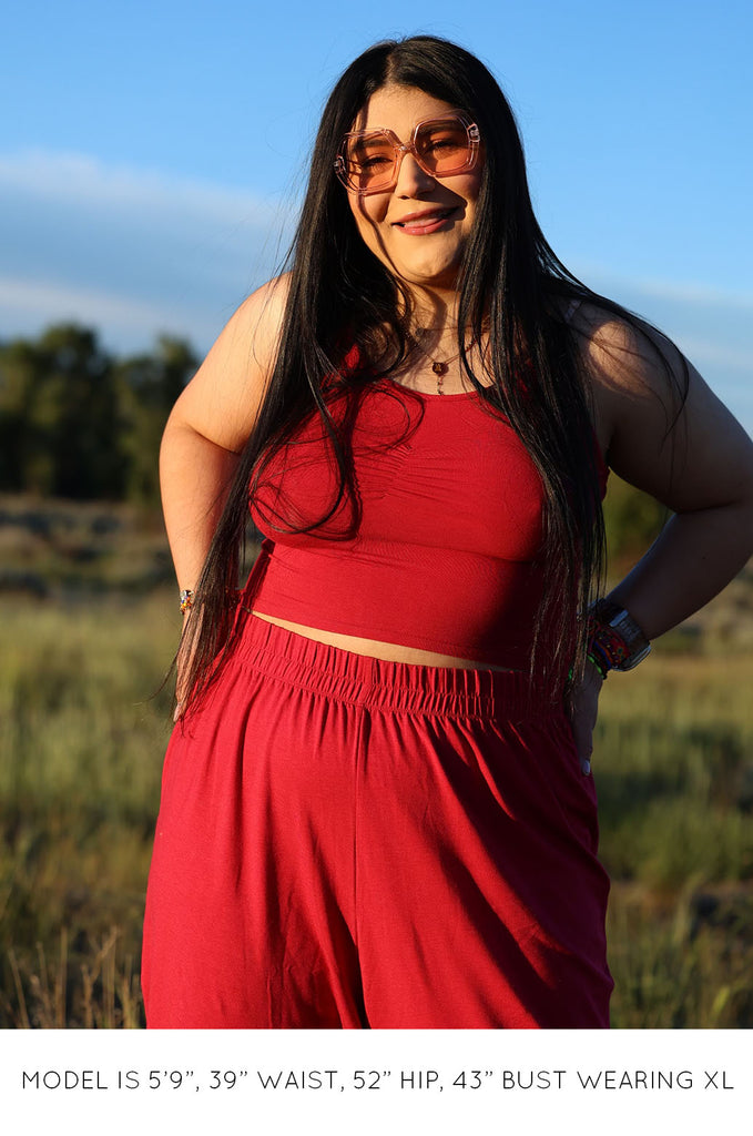 Model wearing a pink Miakoda Brami crop top. 