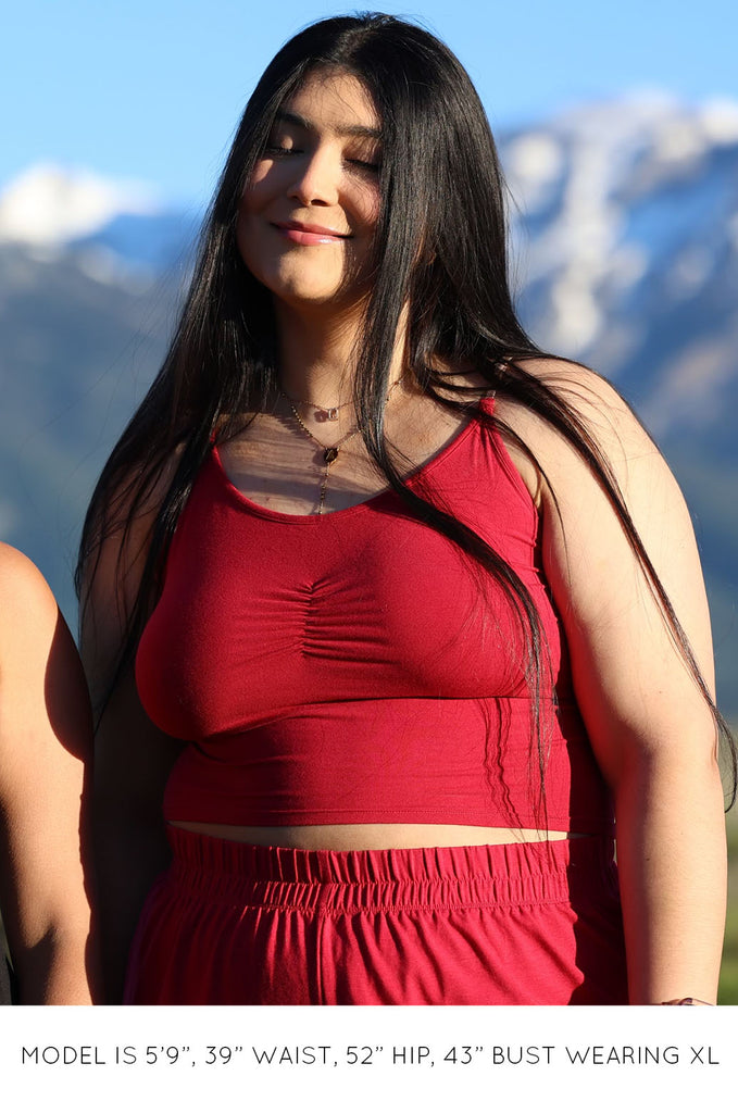 Model wearing pink Miakoda Brami crop top. 