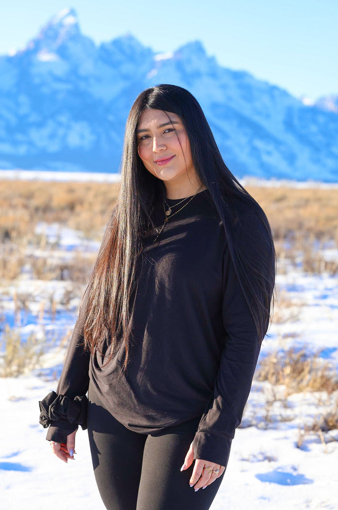 Model wearing black oversized long sleeve tshirt by Miakoda. 