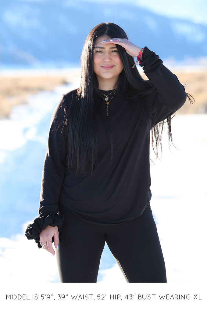 Model wearing black oversized long sleeve tshirt by Miakoda. 