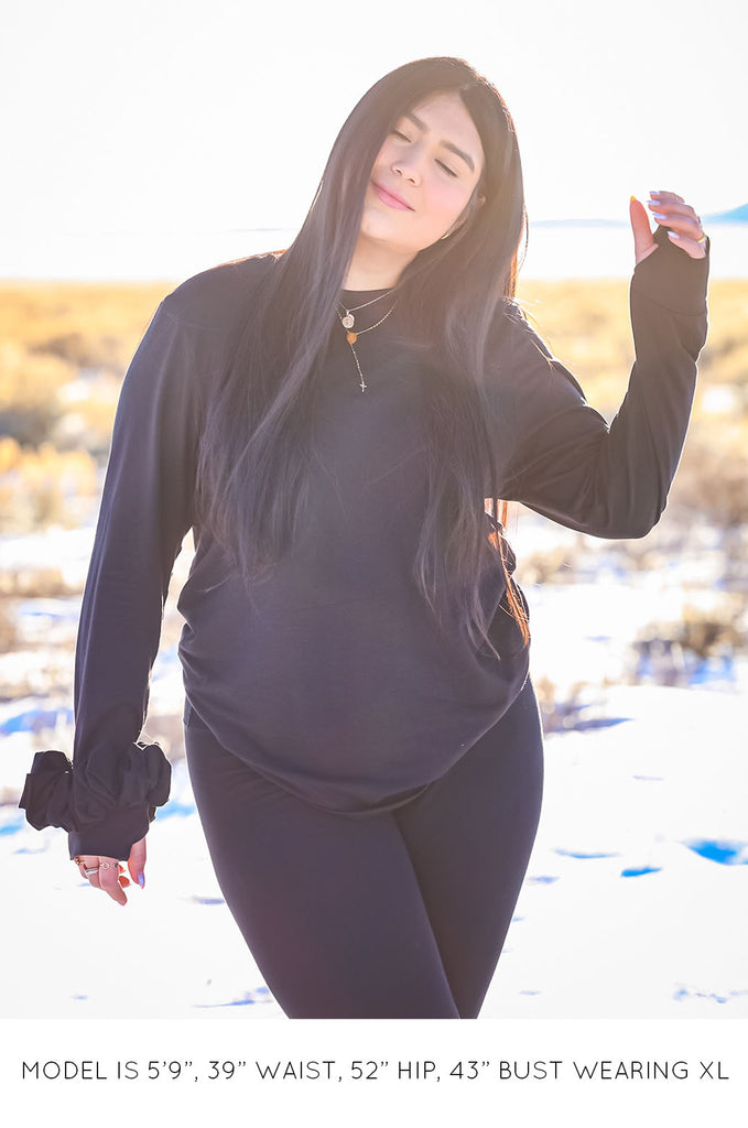 Model wearing black oversized long sleeve tshirt by Miakoda. 