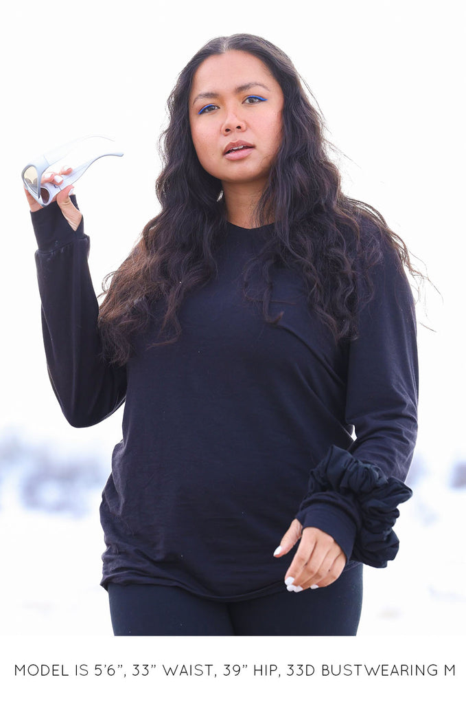 Model wearing black oversized long sleeve tshirt by Miakoda. 