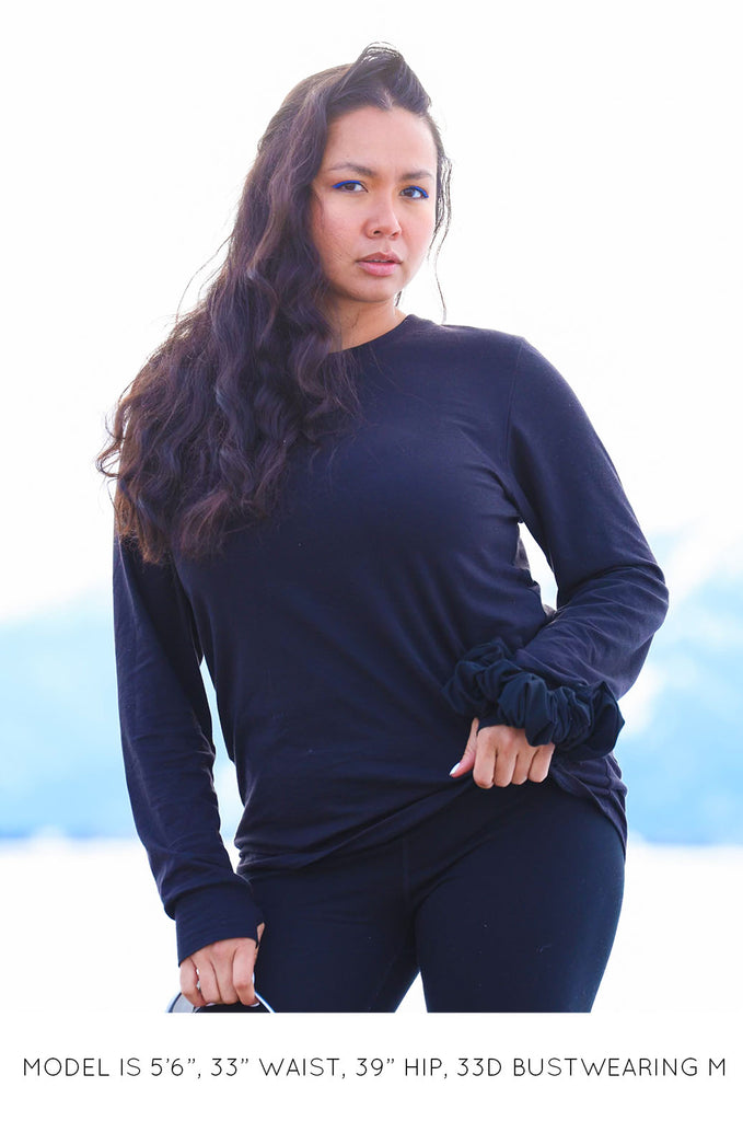 Model wearing black oversized long sleeve tshirt by Miakoda. 