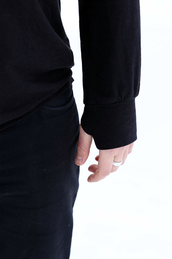Close-up of sleeve detail on the black oversized long sleeve tshirt by Miakoda. 
