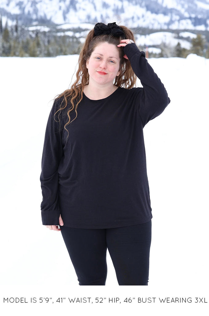 Model wearing black oversized long sleeve tshirt by Miakoda. 