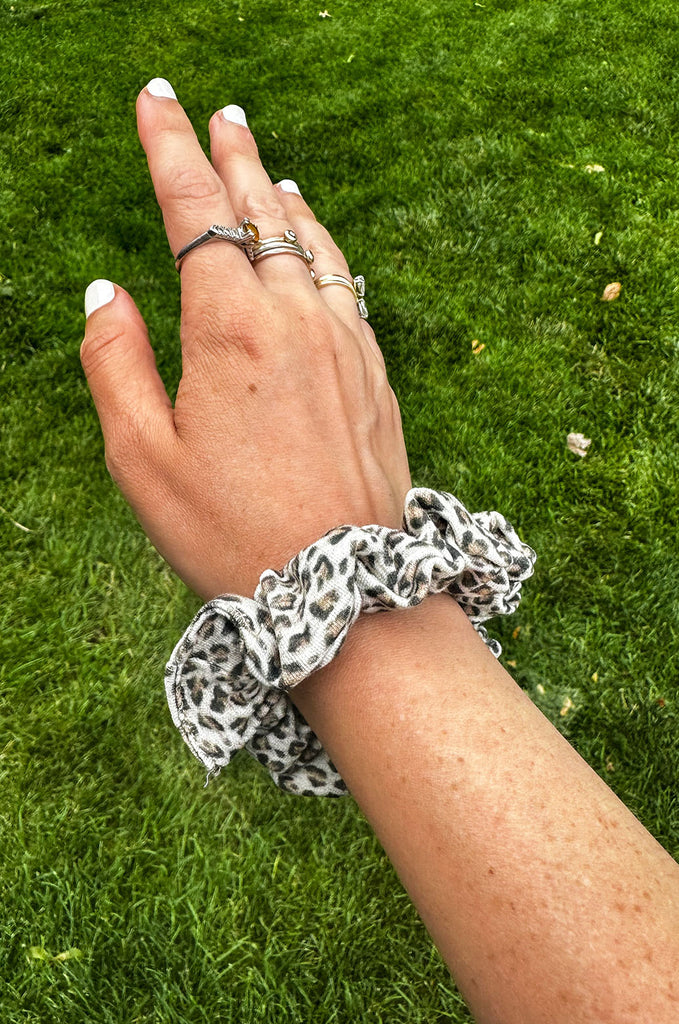 Leopard print scrunchie on arm. 