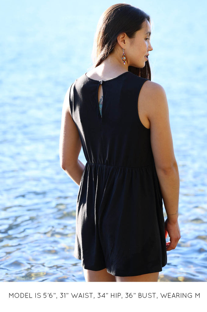 Back view of model by lake wearing black Summer Romper by Miakoda. 