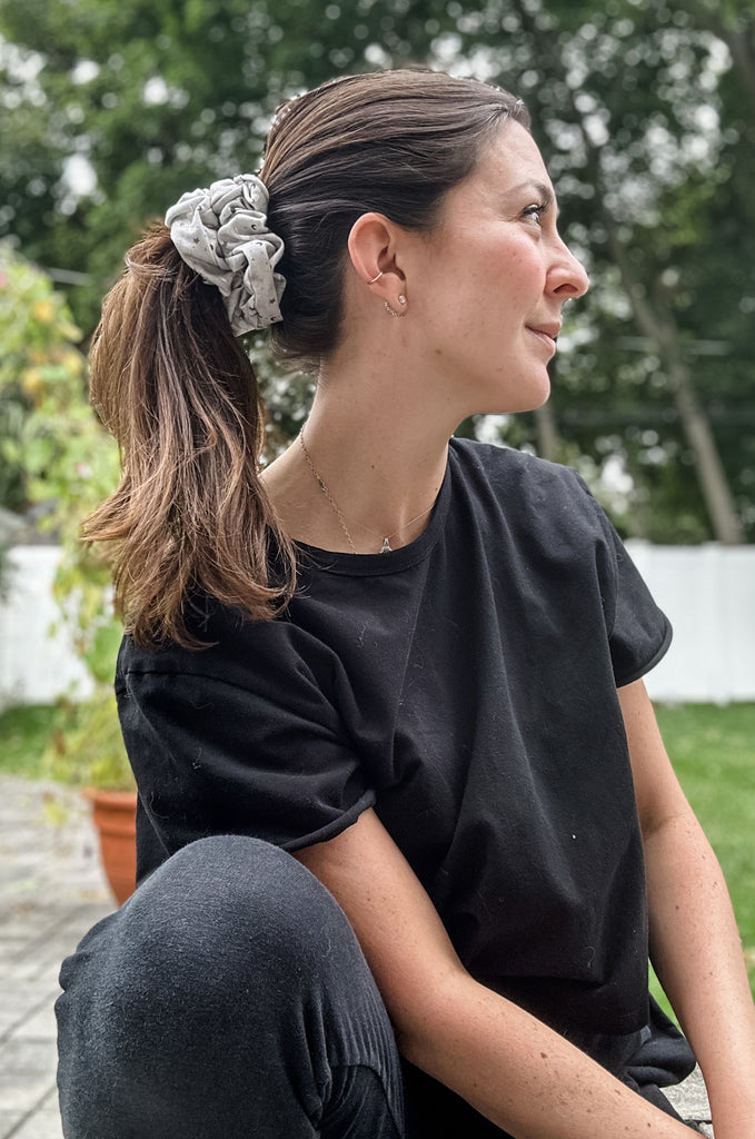 Woman wearing grey print scrunchie by Miakoda. 